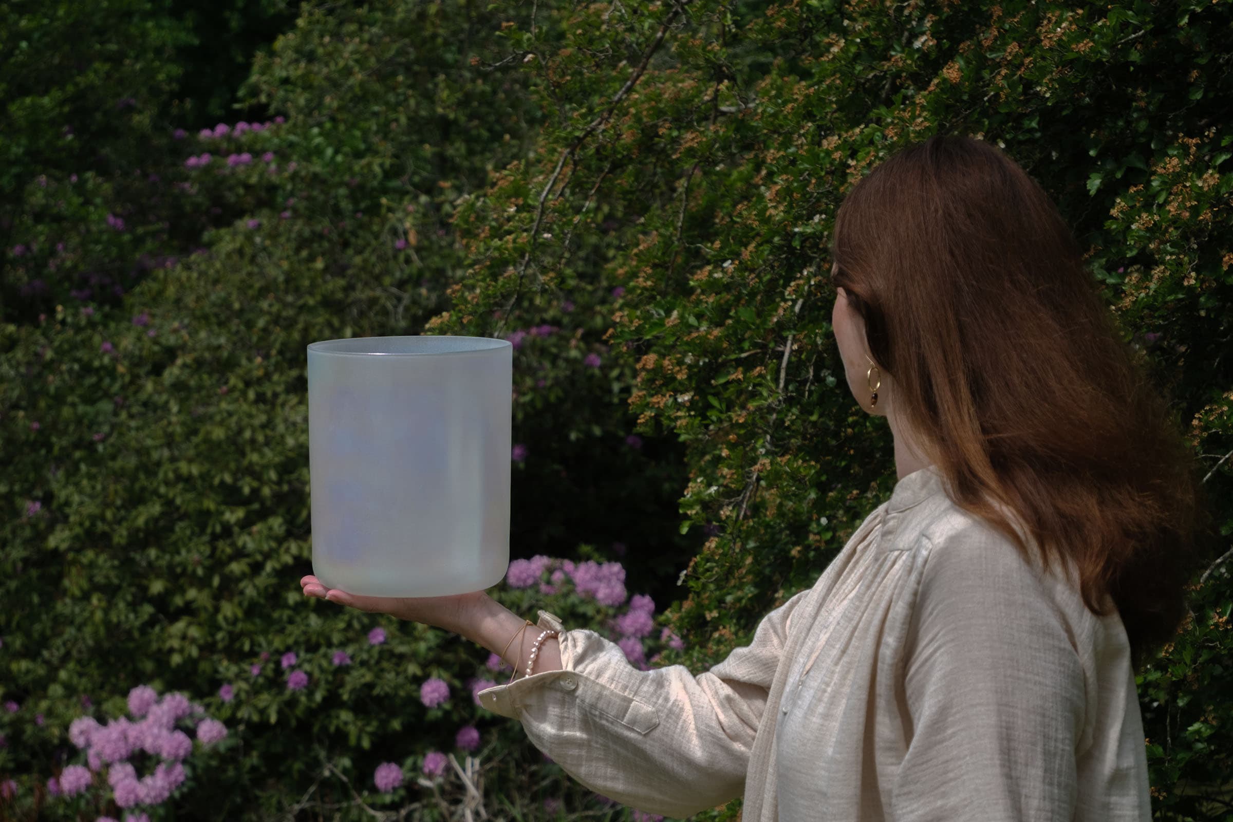 Gabi holding a crystal bowl in nature